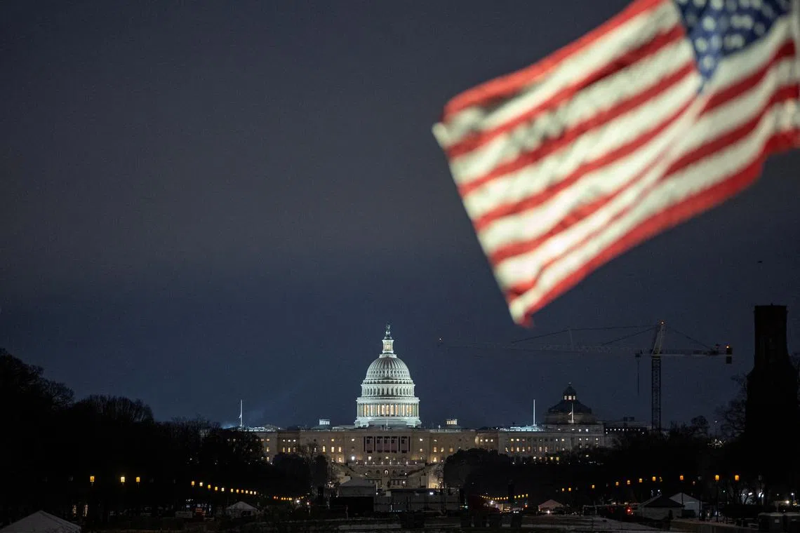 FILE PHOTO: The U.S. flag flutters in front of the U.S. Capitol building in Washington, U.S., January 16, 2025. REUTERS/Marko Djurica/File Photo