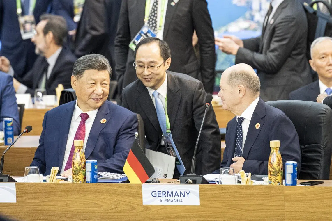 Chinese President Xi Jinping (left) told German Chancellor Olaf Scholz on Nov 19 he hoped Germany could help the EU and China to resolve the issue of tariffs on Chinese electric vehicles.