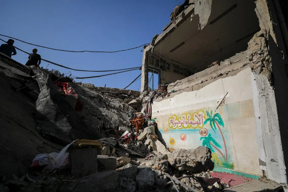 Palestinians view the damage at a school-turned-shelter hit in an Israeli strike on Sunday, amid the ongoing Israel-Hamas conflict, at Beach camp in Gaza City, October 28, 2024. REUTERS/Dawoud Abu Alkas
