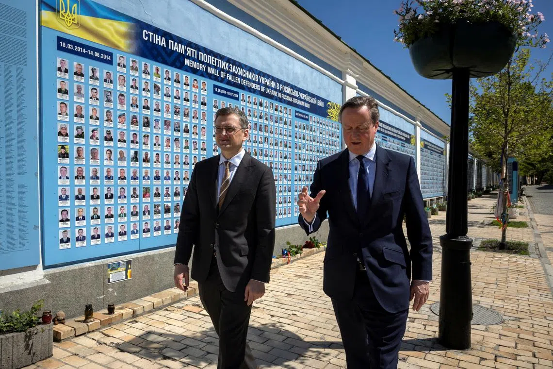 Ukrainian Foreign Minister Dmytro Kuleba (left) and British Foreign Secretary David Cameron walking in Kyiv, on May 2, 2024.