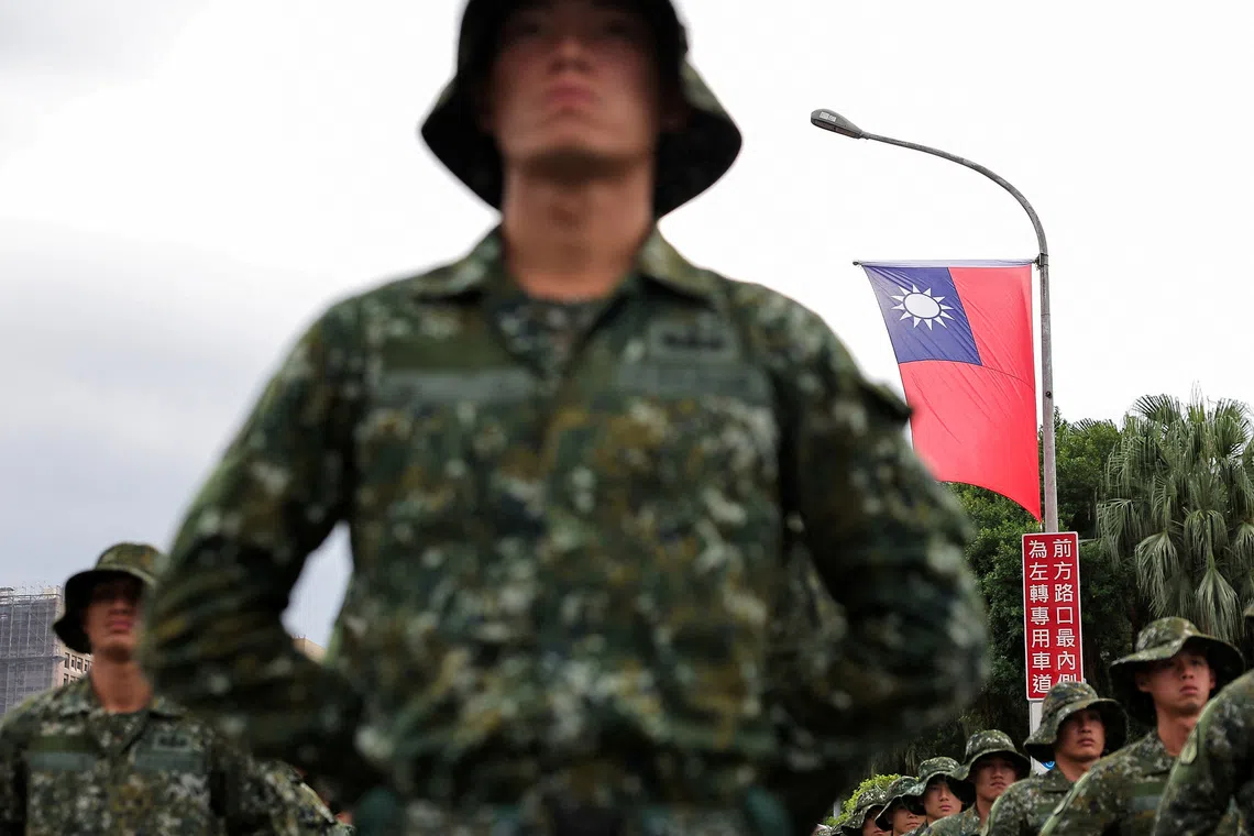 A Taiwan flag flutters in the wind as soldiers prepare to celebrate national day to mark the 113th birthday of the Republic of China, Taiwan's formal name, in Taipei, Taiwan October 10, 2024. REUTERS/Ann Wang