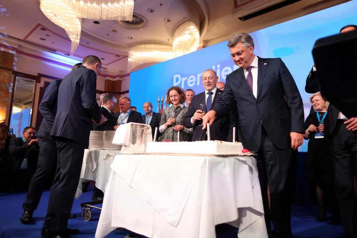 Andrej Plenkovic,  Prime Minister of Croatia, splits a cake following the preliminary results of the country's parliamentary election, in Zagreb, Croatia, April 18, 2024.  REUTERS/Antonio Bronic/ File Photo