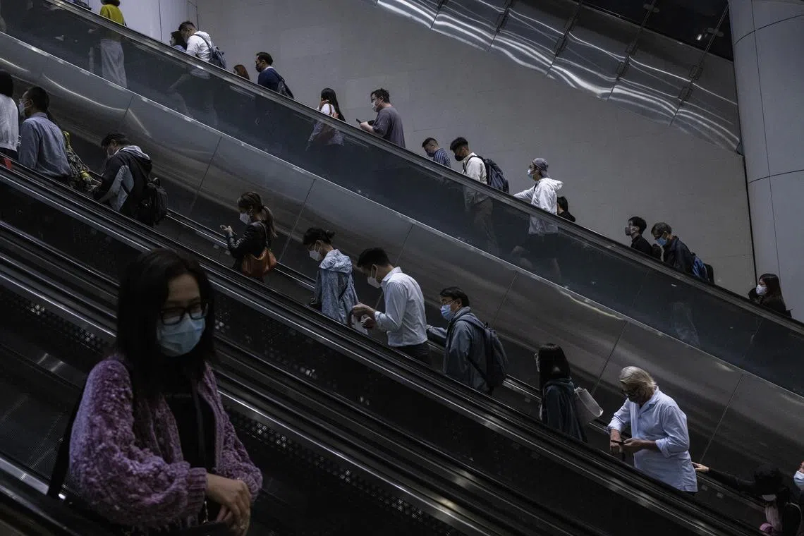 Commuters at an MTR station in Hong Kong, Nov. 3, 2022. Three splashy events this week were meant to prove that Hong Kong was still “Asia’s World City.” But Covid exemptions were provided for visitors from overseas, especially the wealthy ones. (Louise Delmotte/The New York Times)