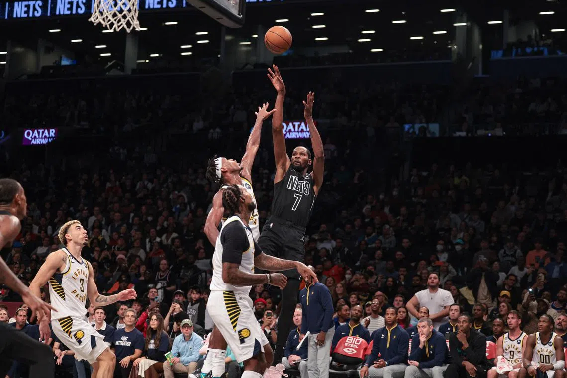 Brooklyn Nets forward Kevin Durant shooting against Indiana Pacers guard Buddy Hield and forward James Johnson (16) during the first half at Barclays Centre. Durant's game tally of 36 points helps him move to the 19th spot on the NBA’s all-time scoring list on 25, 754 points.
