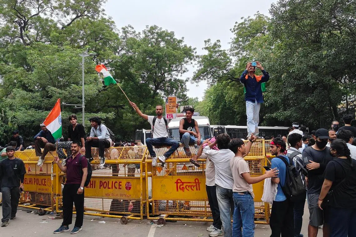 ddprotest20 - Protesters atop one of the many police barricades that had been placed in central New Delhi to prevent them from marching to the Parliament. Credit: Debarshi Dasgupta
