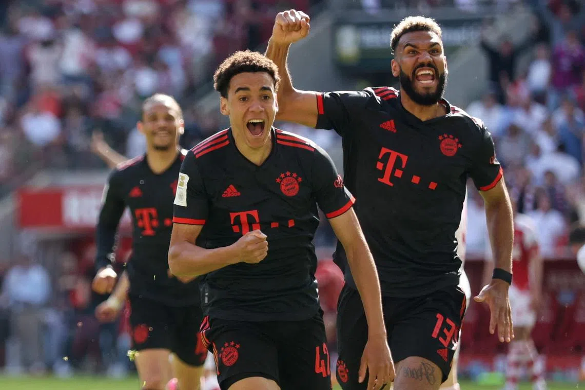 Bayern Munich's Jamal Musiala celebrates scoring the second, winning goal with Eric Maxim Choupo-Moting.