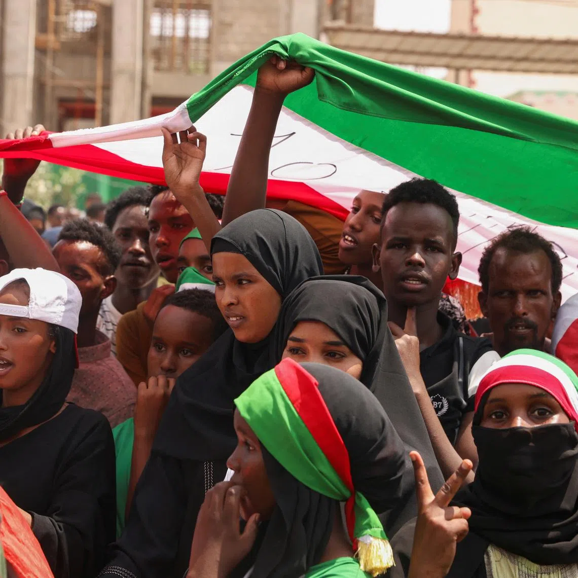People hold the flag of Somaliland during the parade in Hargeisa, Somaliland, May 18, 2024.