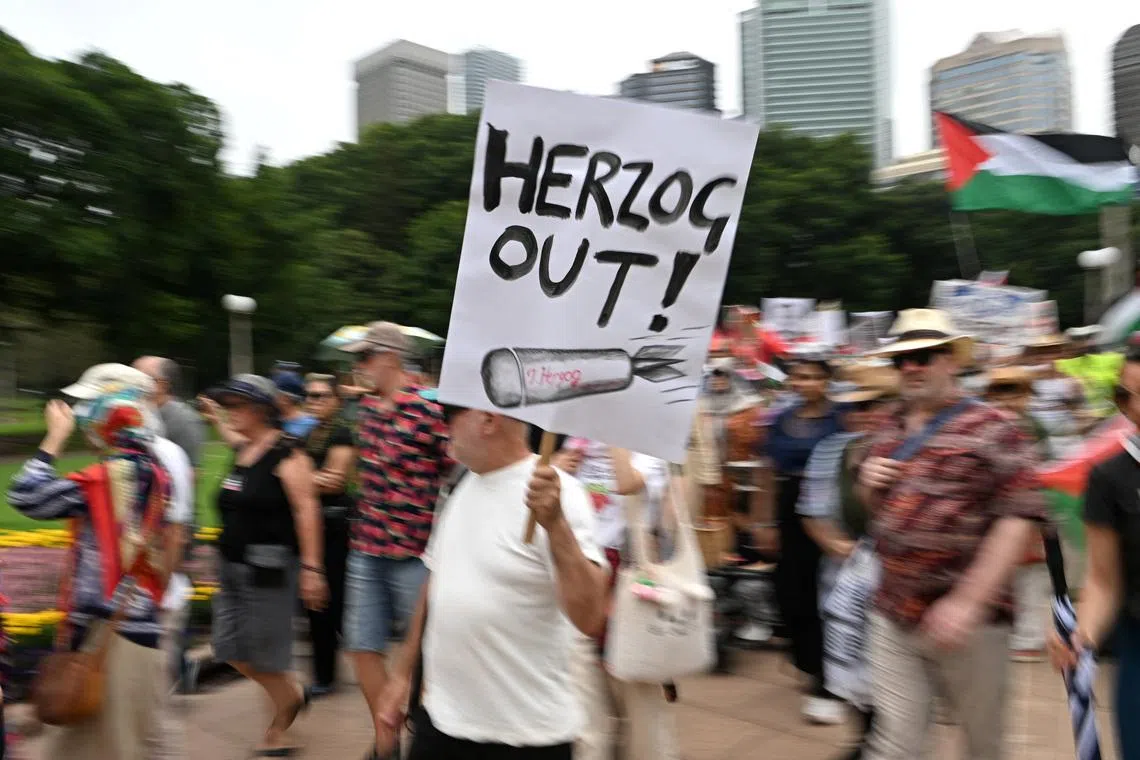 A man holds a placard during a protest on Feb 1 against Israeli President Isaac Herzog's upcoming visit to Australia.