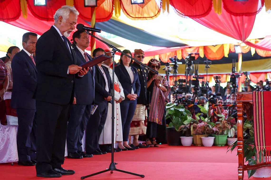 Timor-Leste’s new Prime Minister Xanana Gusmao (L) takes an oath during his inauguration at the presidential palace in Dili.