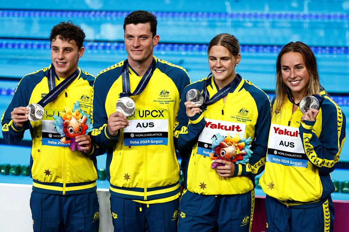 FILE PHOTO: Swimming - World Aquatics Championships - Aspire Dome, Doha, Qatar - February 17, 2024 Silver medallists Australia's Kai James Taylor, Jack Cartwright, Shayna Jack and Brianna Throssell celebrate during the mixed 4x100m freestyle relay final medal ceremony REUTERS/Clodagh Kilcoyne/File Photo