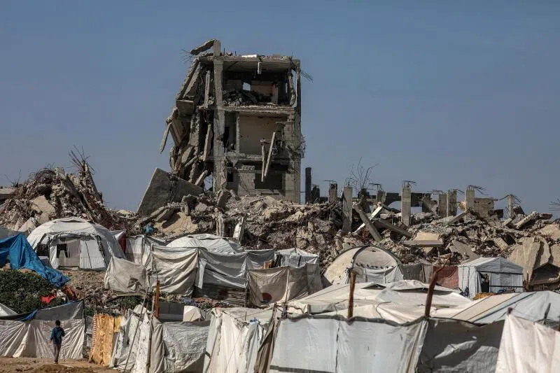  Makeshift tents of displaced Palestinian families among the ruins of the Al-Zaitun neighborhood of Gaza City, on Feb 12, amid a ceasefire between Israel and Hamas. 