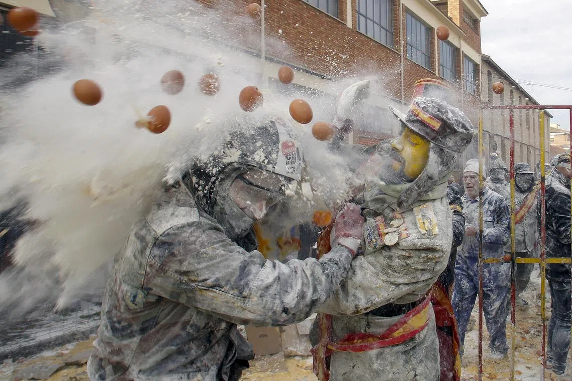 People dressed in miltary costumes taking part in a fake coup d'etat performances during the traditional fest called 'The floured ones' (Els Enfarinats) held in the village of Ibi, Alicante, Spain, Dec 28, 2023. 