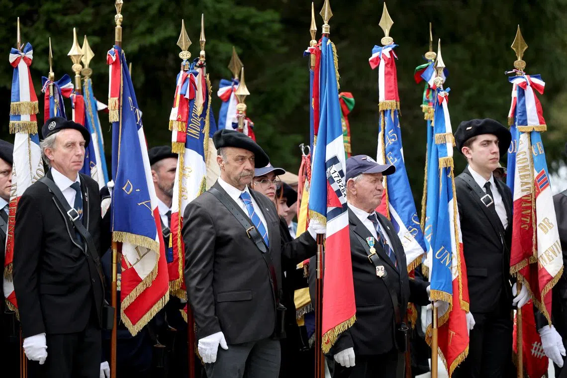 FILE PHOTO: Veterans listen to French President Emmanuel Macron's speech as he pays his respects to World War II resistance fighters killed at the Glieres Plateau, during a ceremony to commemorate the 80th anniversary of the battle of Glieres, at the Glieres National Necropolis of Morette, a military cemetery in Thones, France, April 7, 2024. REUTERS/Pierre Albouy/Pool/File Photo