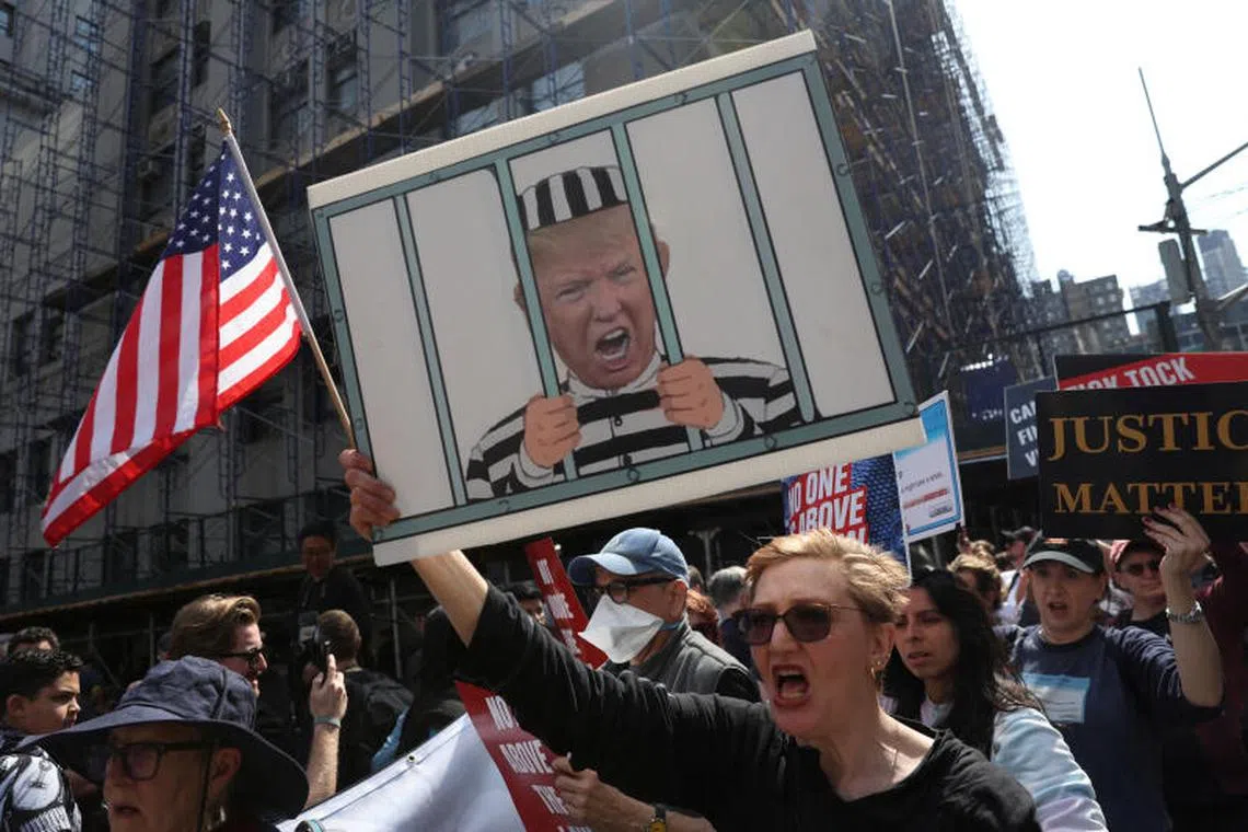People demonstrate outside Manhattan Criminal Courthouse, on the day of former U.S. President Donald Trump's court appearance after his indictment by a Manhattan grand jury following a probe into hush money paid to porn star Stormy Daniels, in New York City, U.S.A on April 4, 2023. 