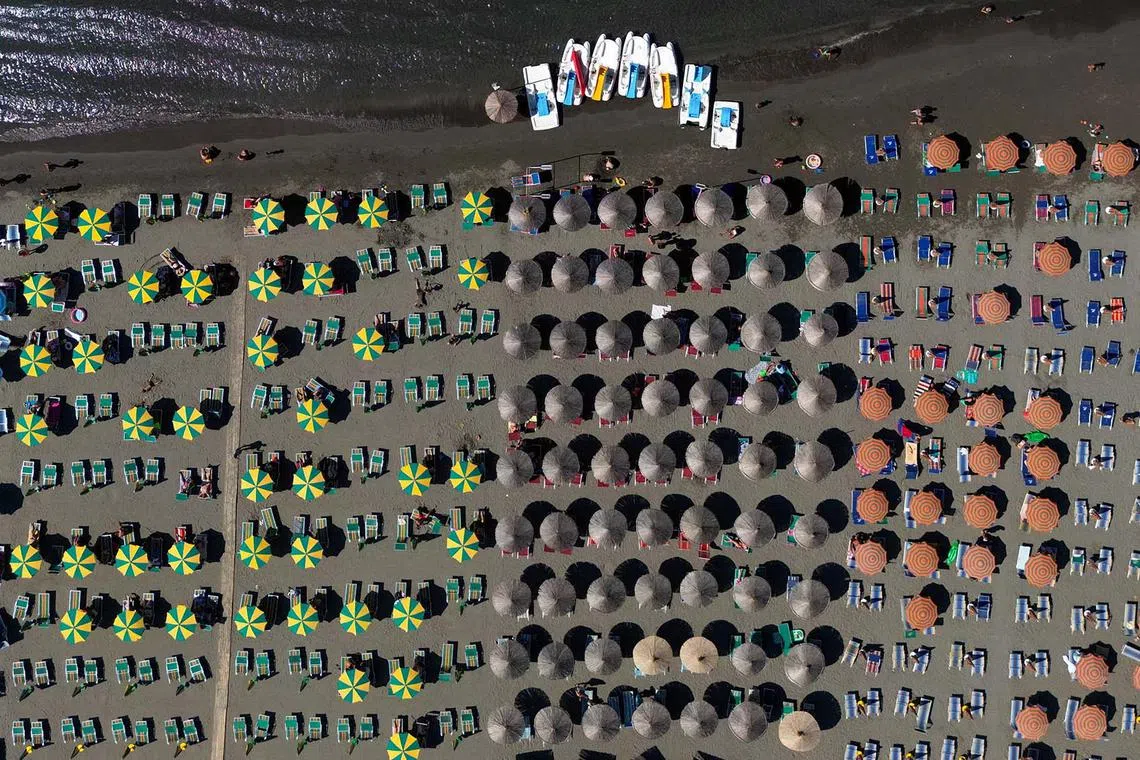 A drone view of parasols on a beach of the Adriatic Sea in Shengjin, Albania, July 31, 2025. 