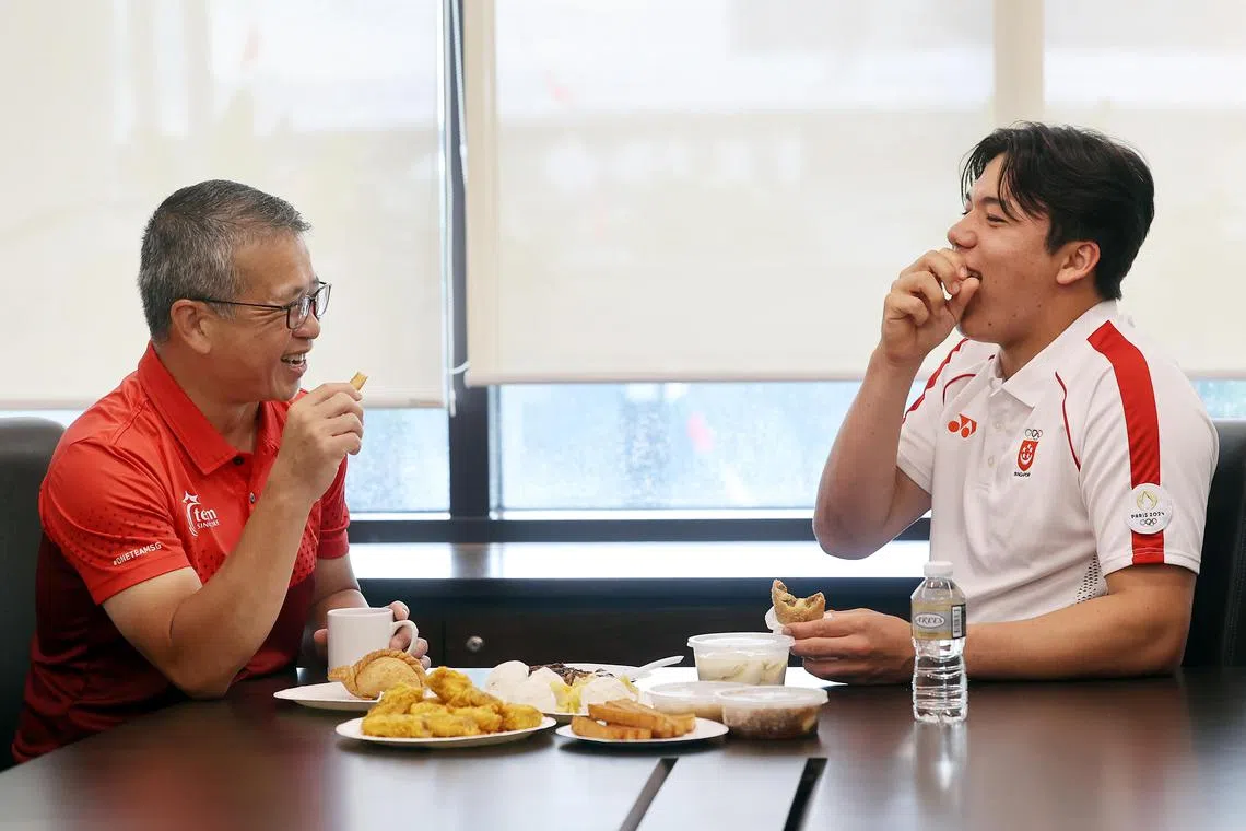 Minister for Culture, Community and Youth Edwin Tong and kitefoiler Maximilian Maeder having breakfast at the People’s Association headquarters on Aug 14.