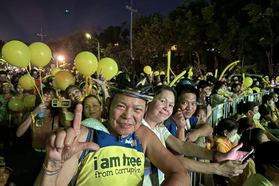 A man does the hand sign for “laban”, or fight, which became a symbol of the anti-Marcos dictatorship resistance, during a concert held to commemorate the People Power anniversary in Manila on Feb 25.