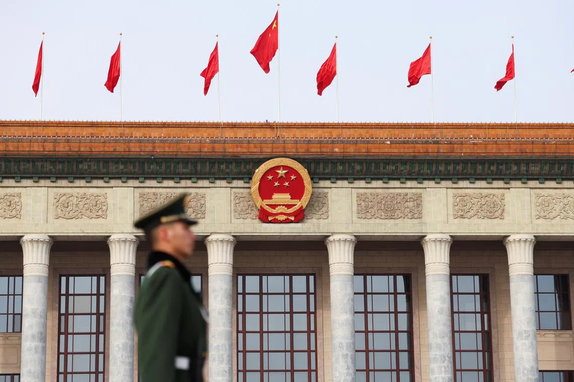 FILE PHOTO: A paramilitary police officer stands guard, on the day of the opening session of the Chinese People's Political Consultative Conference (CPPCC), in front of the Great Hall of the People, in Beijing, China March 4, 2024. REUTERS/Tingshu Wang/File Photo