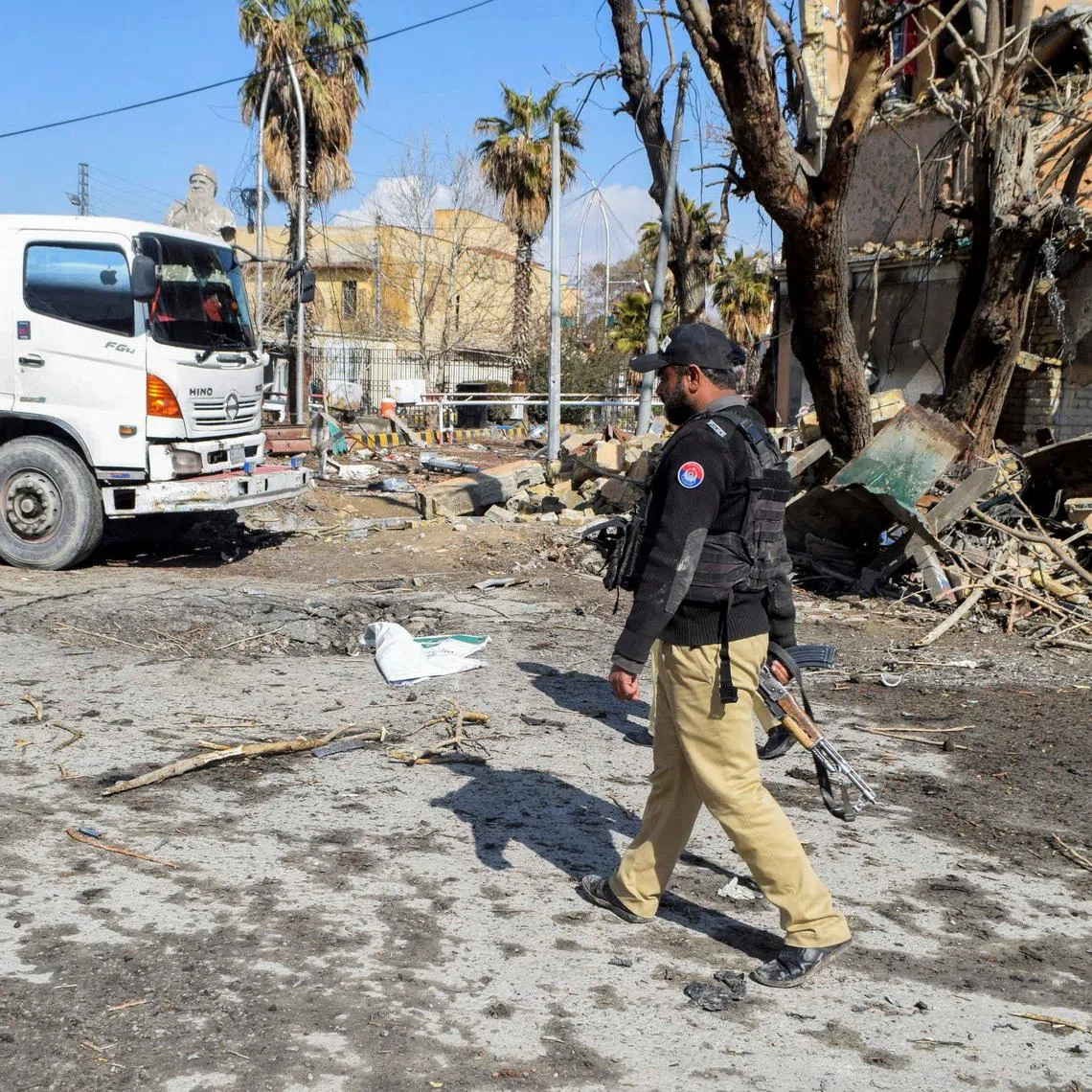 FILE PHOTO: A police officer walks past damage at the site, after militant attacks, in Quetta, Pakistan, February 1, 2026. REUTERS/Stringer/File Photo