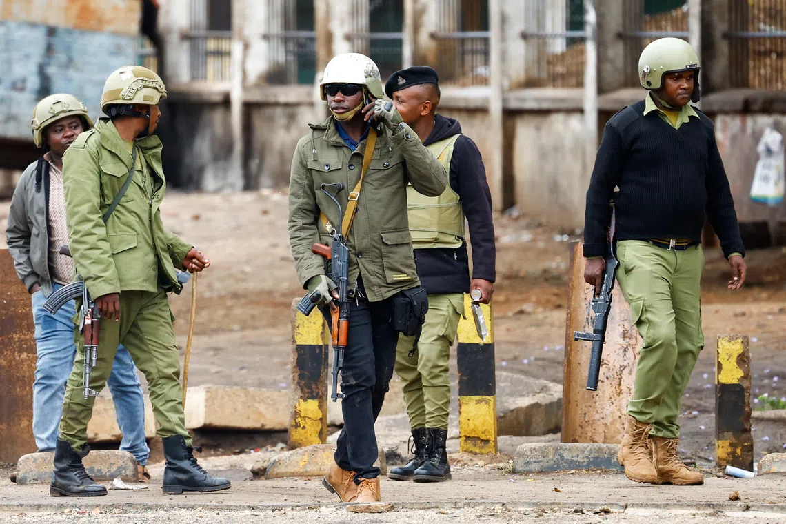 FILE PHOTO: Tanzanian riot police officers walk, following a protest a day after a general election marred by violent demonstrations over the exclusion of two leading opposition candidates at the Namanga One-Post Border crossing point between Kenya and Tanzania, October 30, 2025. REUTERS/Thomas Mukoya/ File Photo