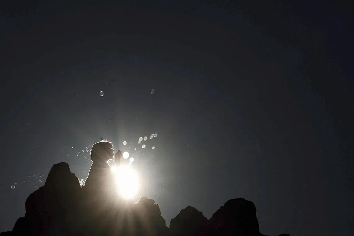 A girl blowing soap bubbles while celebrating the summer solstice at the Kokino Megalithic Observatory in North Macedonia, on June 21.