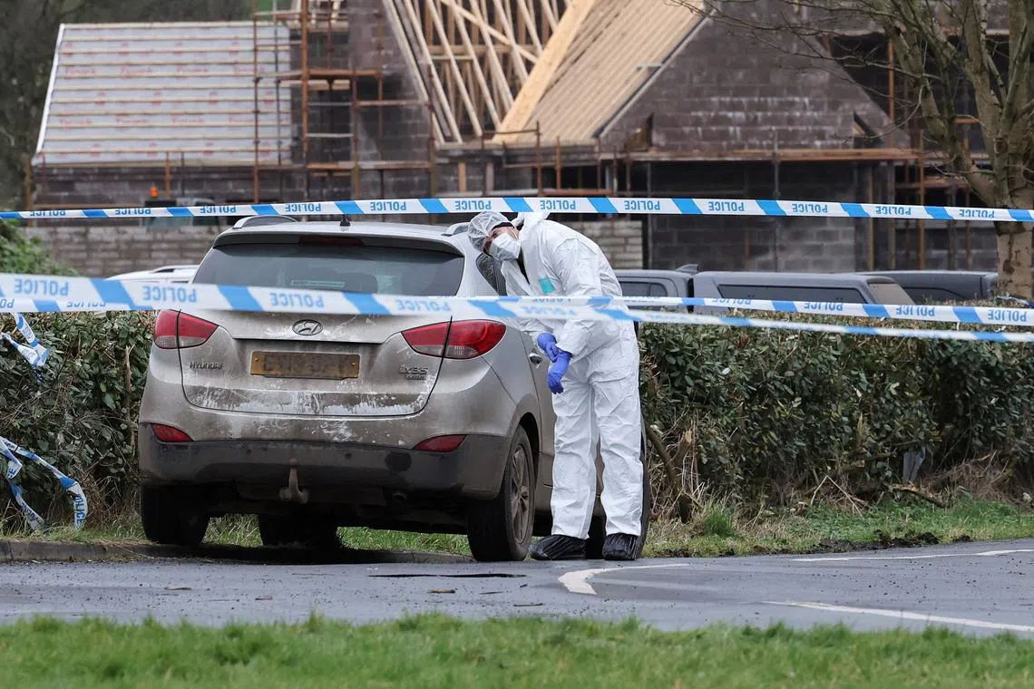 A forensic officer at the scene of the Youth Sport Omagh sports complex where an off-duty detective was shot, in Omagh, Northern Ireland, on Feb 23. 