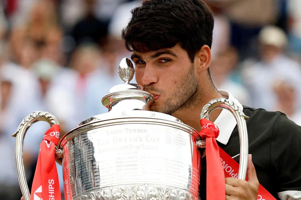 FILE PHOTO: Tennis - Queen's Club Championships - Queen's Club, London, Britain - June 22, 2025 Spain's Carlos Alcaraz celebrates with the trophy after winning his final against Czech Republic's Jiri Lehecka Action Images via Reuters/Peter Cziborra/File Photi