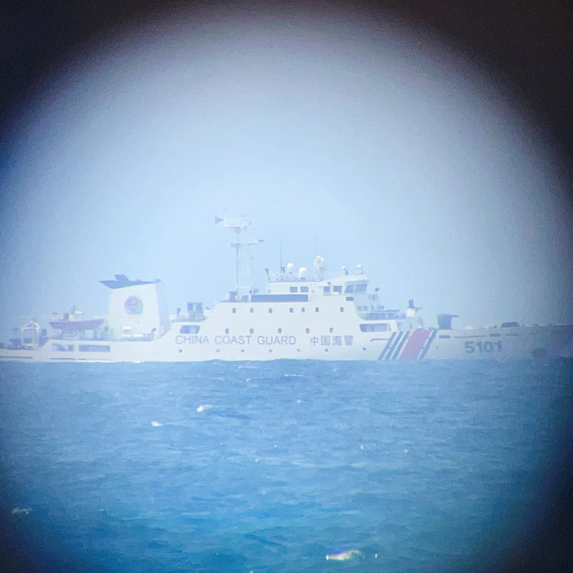 A China Coast Guard ship on the horizon through a telescopic view in Philippine-occupied Thitu Island in the disputed South China Sea on Feb 21.