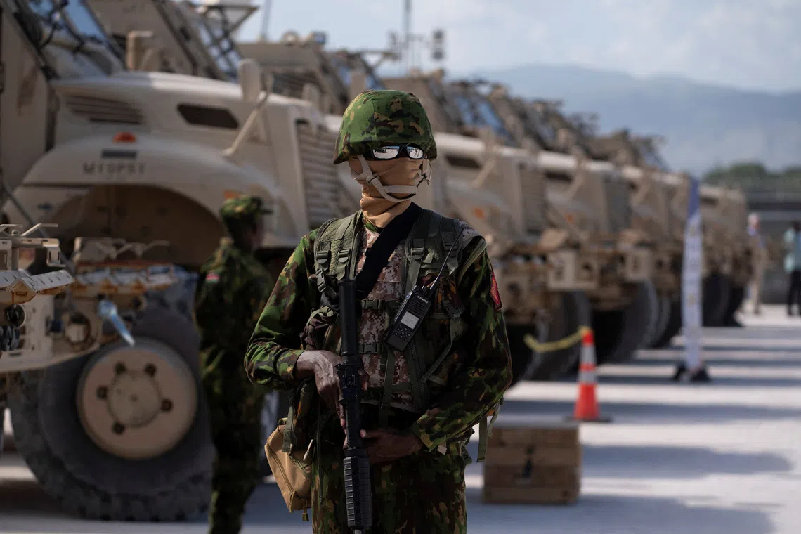 FILE PHOTO: A Kenyan police officer stands next to a row of anti-mine armoured vehicles as the United States Ambassador to the United Nations Linda Thomas-Greenfield tours the Multinational Security Support (MSS) mission in Haiti base near the airport in Port-au-Prince, Haiti, on July 22, 2024.  Roberto Schmidt/Pool via REUTERS/ File Photo