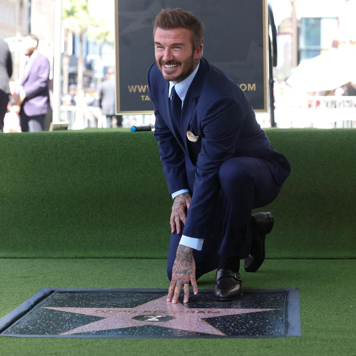 David Beckham posing on his star after it was unveiled on the Hollywood Walk of Fame in Los Angeles on June 12. 