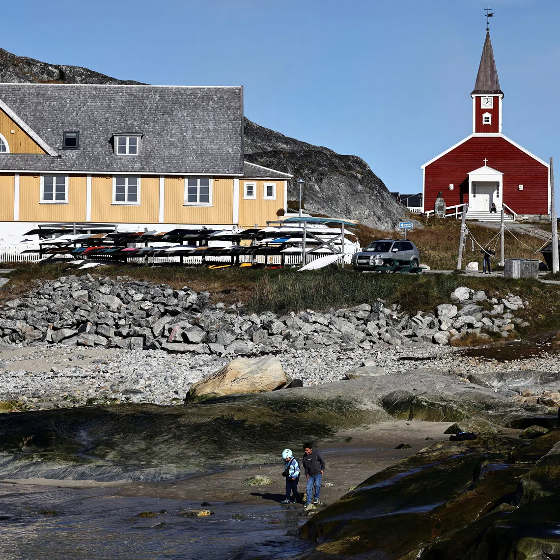 Two children play on the beach in the old harbour area of Nuuk, Greenland, September 22, 2026. REUTERS/Tim Barsoe