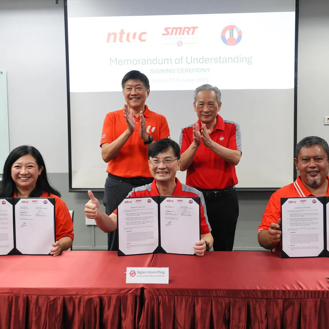 (Seated, from left) NTUC assistant secretary-general and NTWU executive secretary Yeo Wan Ling, SMRT Group CEO Ngien Hoon Ping and NTWU president Sazali Safiie at the MOU signing ceremony. The signing was witnessed by NTUC secretary-general Ng Chee Meng (standing, left) and SMRT chairman Seah Moon Ming.
