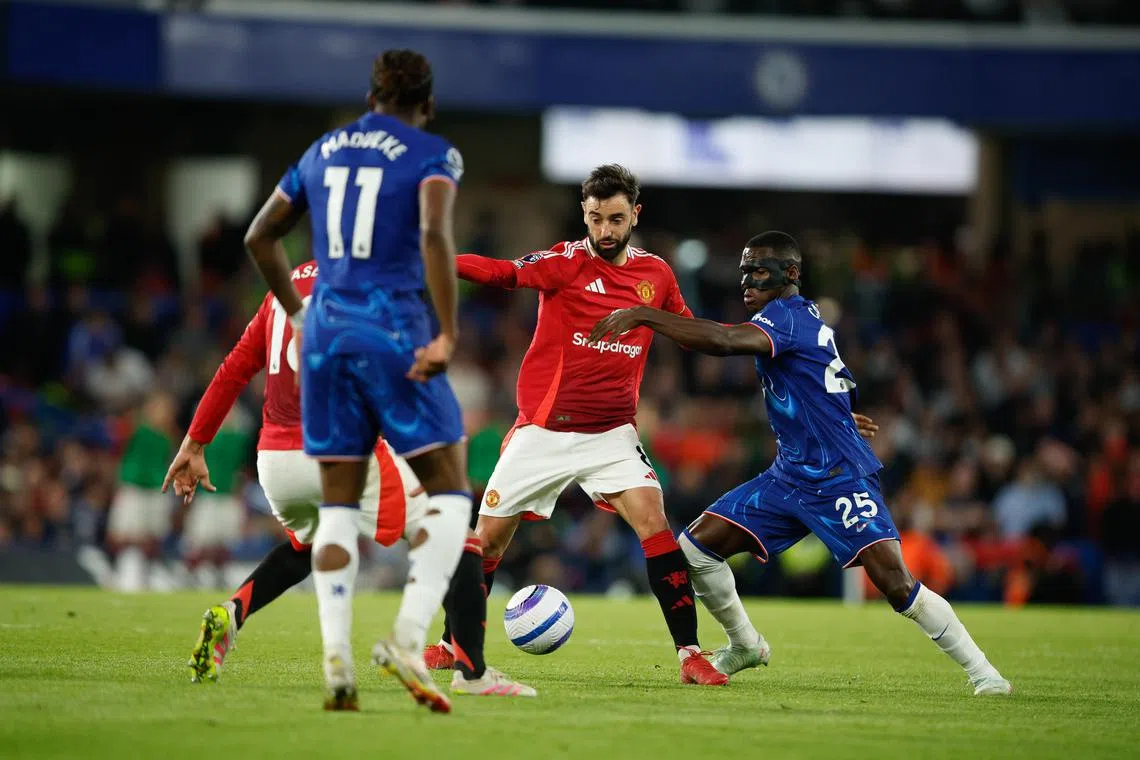 Manchester United captain Bruno Fernandes fighting for the ball in a Premier League clash with Chelsea.