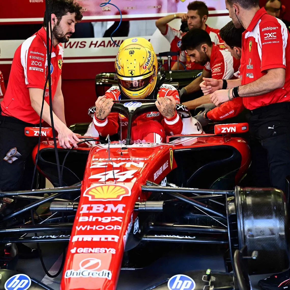 Ferrari's British driver Lewis Hamilton getting ready for the first day of the Formula One pre-season testing at the Bahrain International Circuit in Sakhir on Feb 11, 2026. 