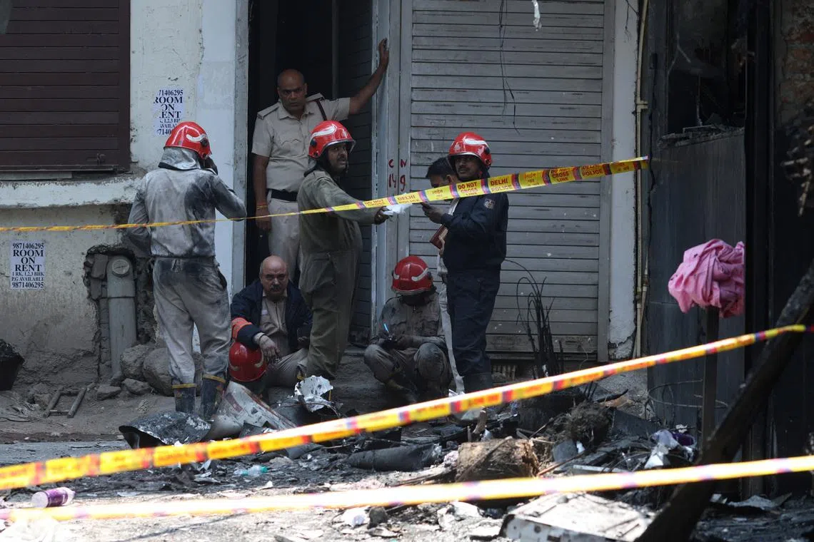 Firefighters at work after a fire at a hotel in New Delhi, India, on June 3.