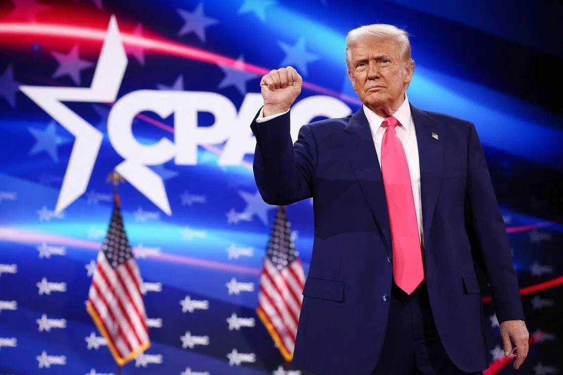 OXON HILL, MARYLAND - FEBRUARY 22: U.S. President Donald Trump reacts to the crowd while arriving at the Conservative Political Action Conference (CPAC) at the Gaylord National Resort Hotel and Convention Center on February 22, 2025 in Oxon Hill, Maryland. The annual four-day gathering brings together conservative U.S. lawmakers, international leaders, media personalities and businessmen to discuss and champion conservative ideas.   Win McNamee/Getty Images/AFP (Photo by WIN MCNAMEE / GETTY IMAGES NORTH AMERICA / Getty Images via AFP)