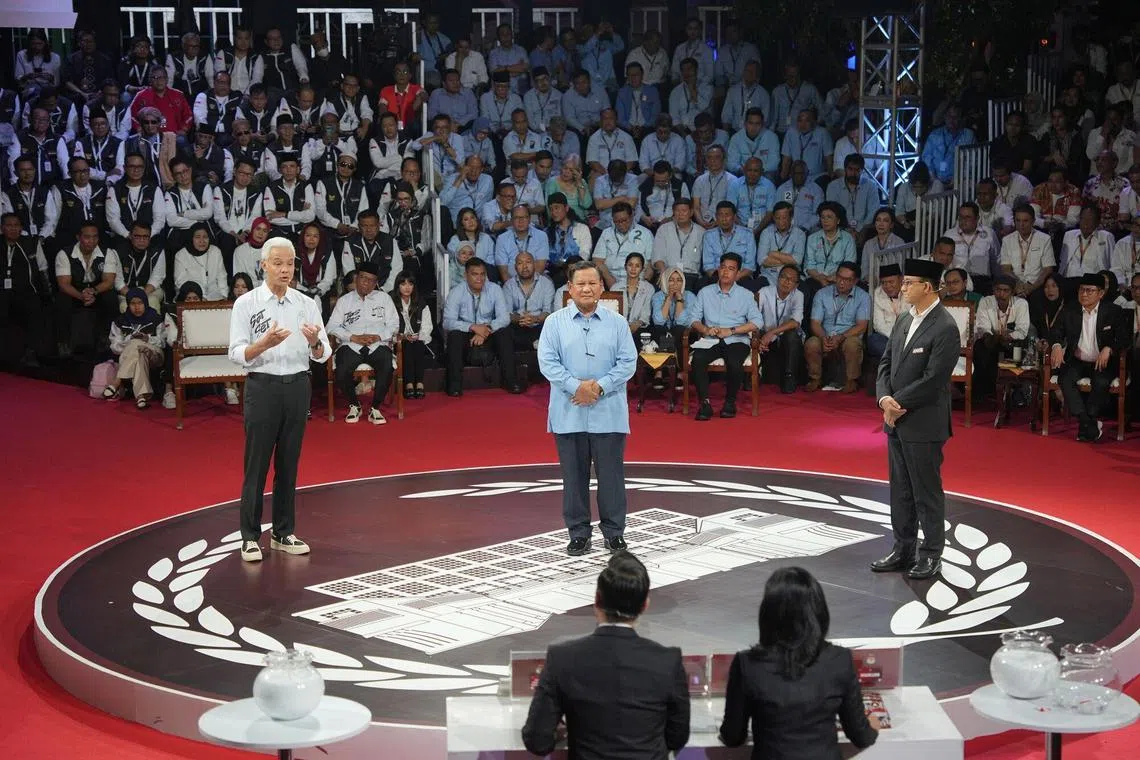 Ganjar Pranowo, presidential candidate and former Central Java governor, left, Prabowo Subianto, presidential candidate and Indonesia's defense minister, center, and Anies Baswedan, presidential candidate and former Jakarta governor, during the first presidential debate in Jakarta, Indonesia, on Tuesday, Dec. 12, 2023. Indonesia's election campaign is in full swing, with the candidates facing off on Tuesday in their first out of five debates. More than 200 million people are expected to cast their votes in February for who would lead the world's third-largest democracy. Photographer: Dimas Ardian/Bloomberg