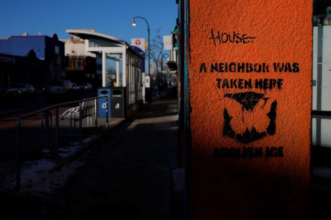 FILE PHOTO: A sign on a wall reads \"A Neighbour Was Taken Here,\" indicating a place where someone was detained by federal immigration agents, in Minneapolis, Minnesota, U.S., January 30, 2026.   REUTERS/Brian Snyder/ File Photo
