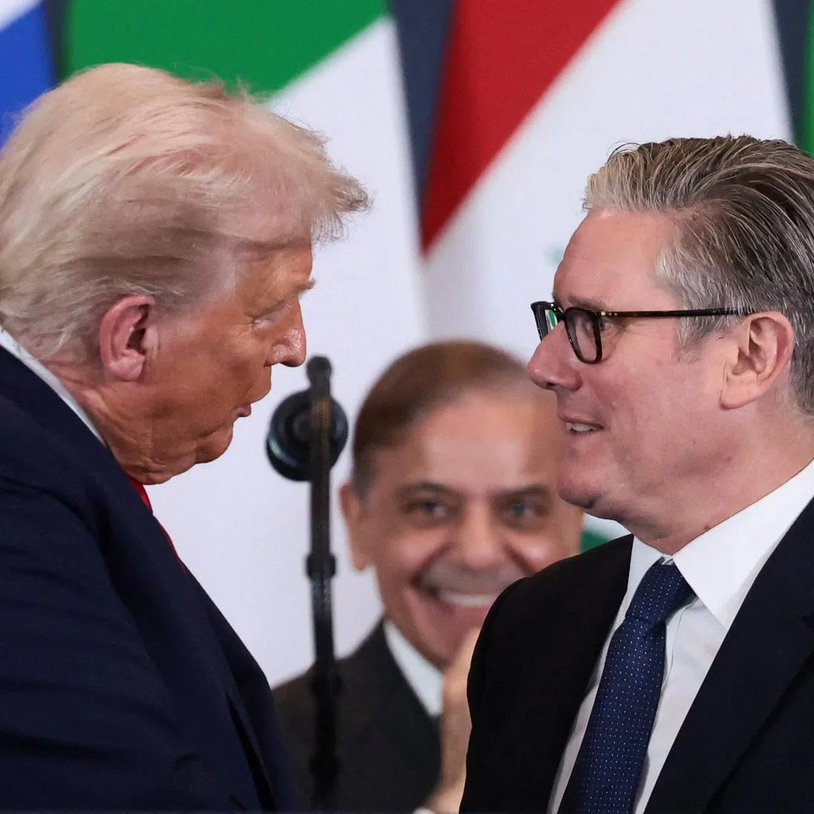 U.S. President Donald Trump talks to British Prime Minister Keir Starmer following the official signing of the first phase of the Gaza ceasefire agreement between Israel and Hamas, during a world leaders' summit on ending the Gaza war, in Sharm El-Sheikh, Egypt, October 13, 2025. REUTERS/Evelyn Hockstein