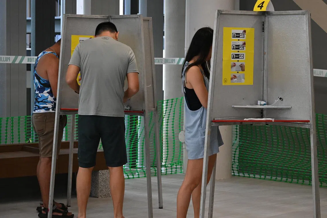 Voters casting their ballots at an HDB pavilion during the 2025 General Election on May 3.