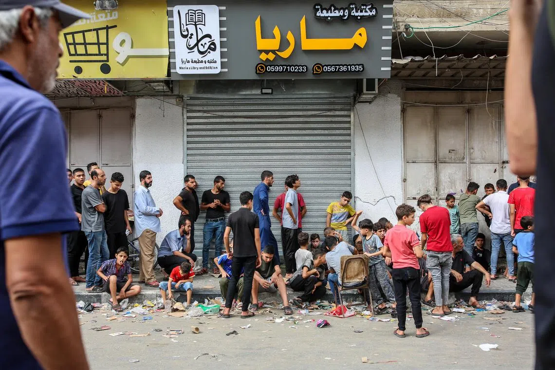 People line up at a bakery in Khan Younis, southern Gaza Strip on Friday.