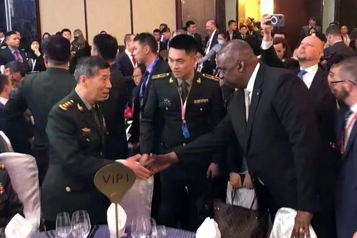 Chinese Defence Minister Li Shangfu (left) and US defence secretary Lloyd Austin (second from right) shaking hands at the opening night of the Shangri-la Dialogue, on June 2.