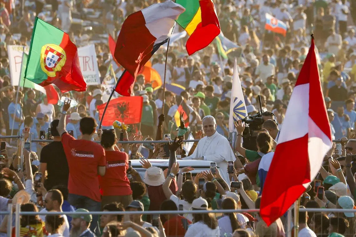 Pope Leo XIV (centre) greeting young Catholics from his popemobile, in Rome, Italy, on Aug 2.