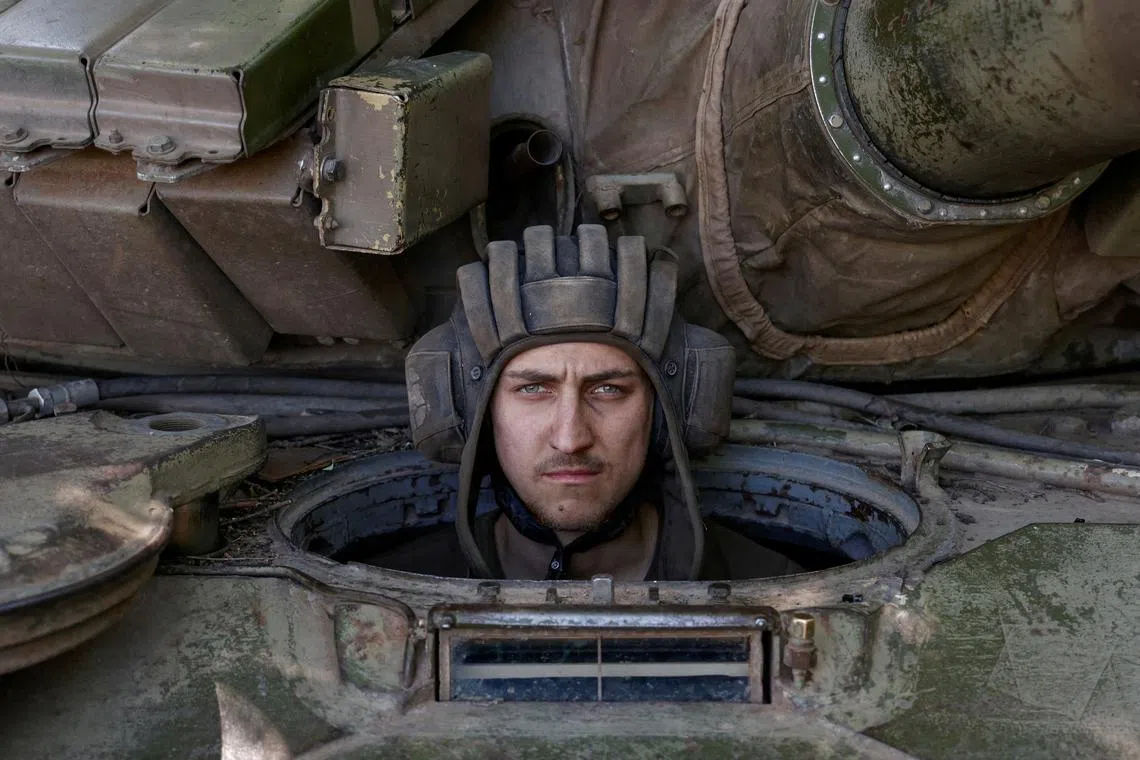 A Ukrainian serviceman looks on from inside a tank at a position in Donetsk region, as Russia's attack on Ukraine continues, June 11, 2022. 