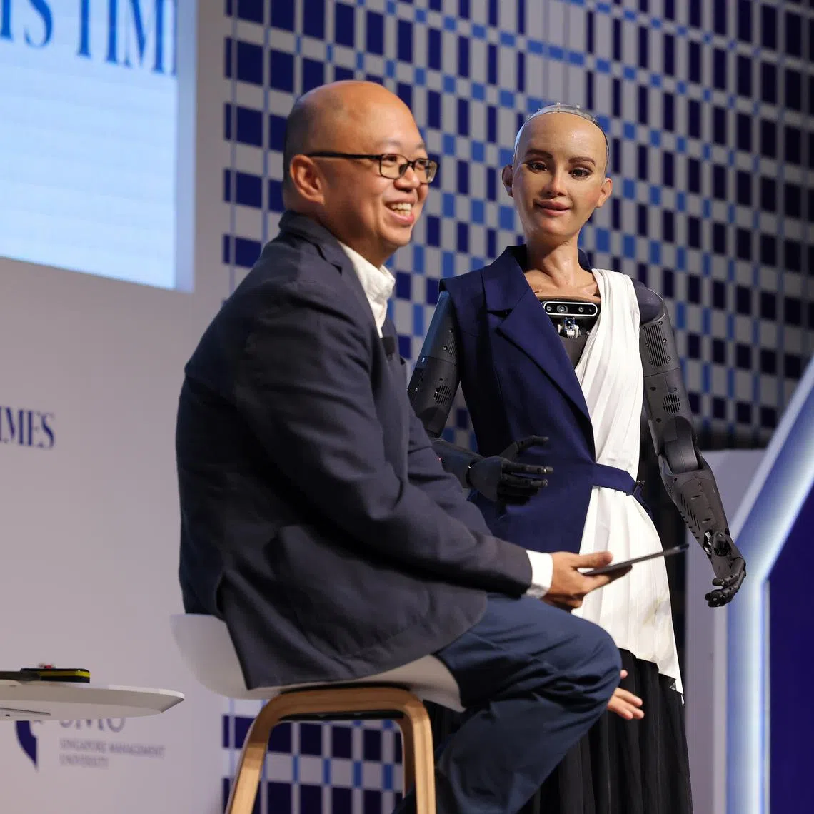 ST newsroom strategy editor Jeremy Au Yong with Sophia, the world’s first humanoid robot, at The Straits Times Education Forum 2024.