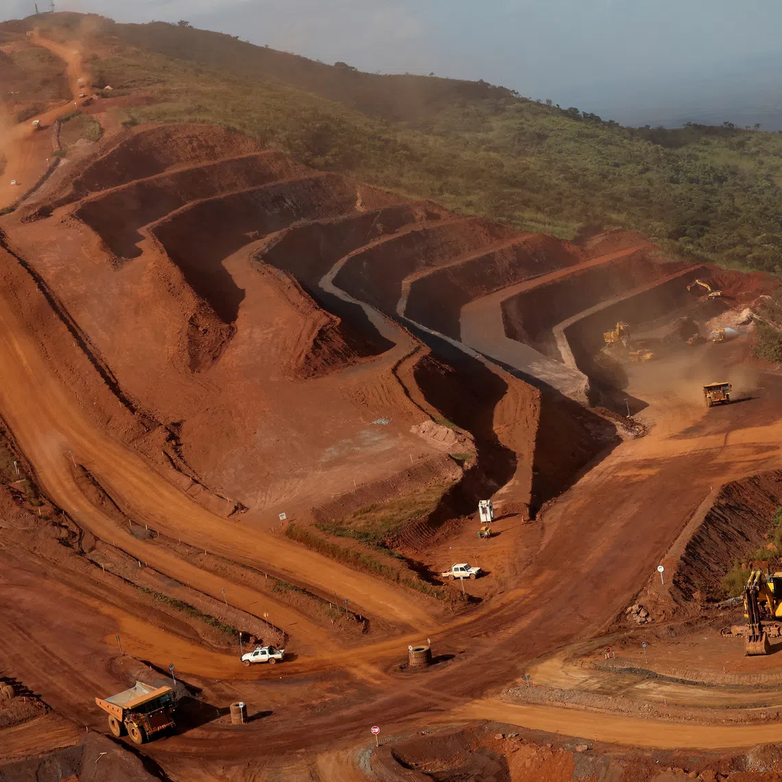 FILE PHOTO: Mining vehicles operate at the blocks three and four of the Simandou mine, one of the largest high-grade iron ore deposits, run by Rio Tinto and partners' joint venture, SimFer, in the Nzerekore Region, Guinea November 4, 2025. REUTERS/Luc Gnago/File Photo