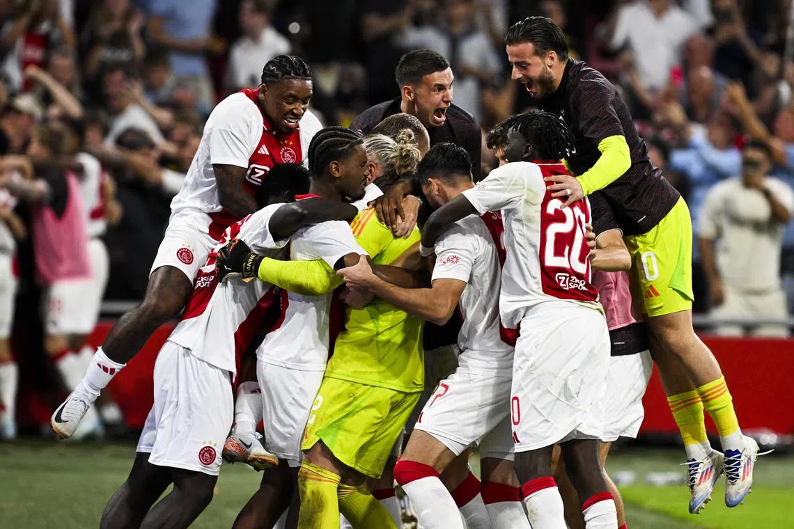 Ajax Amsterdam celebrate after winning a hard-earned penalty shoot-out 13-12 against Panathinaikos in the Europa League third qualifying round.