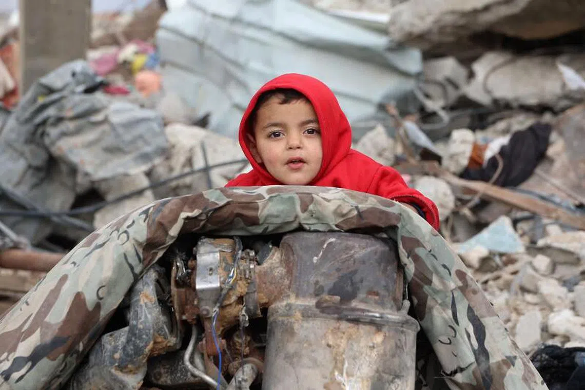 A Palestinian child is pictured amid the rubble of destroyed buildings at Saftawi street in Jabalia, in the northern Gaza Strip, on February 5, 2025 during a ceasefire deal in the war between Israel and Hamas. Palestinian militant group Hamas lashed out on February 5, at President Donald Trump's shock proposal for the United States to take over the Gaza Strip and resettle its people in other countries, seemingly whether they want to leave or not. (Photo by Omar AL-QATTAA / AFP)