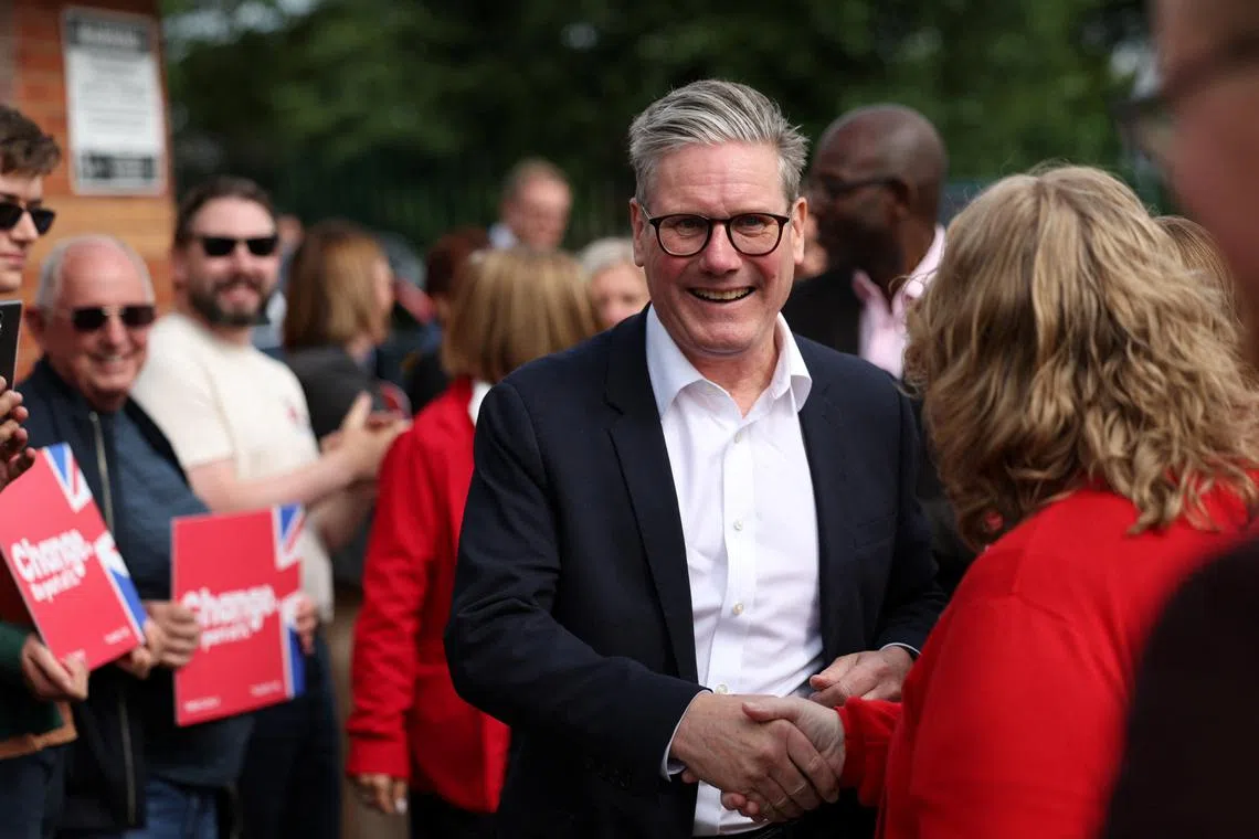 British opposition Labour Party leader Keir Starmer greets a person as he attends a Labour general election campaign event, in Norton Canes, Britain July 2, 2024. REUTERS/Claudia Greco