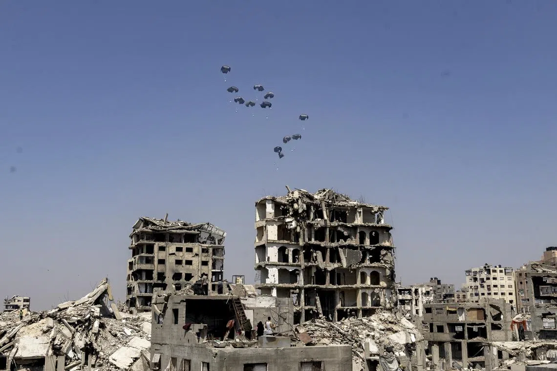 Aid dropped by parachute by a United Arab Emirates aircraft in northern Gaza City.